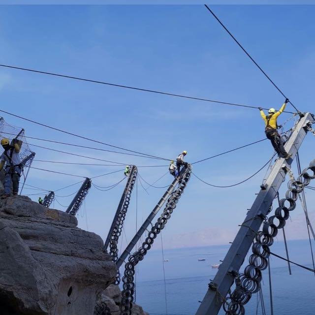 Barrier post erection on a coastal escarpment