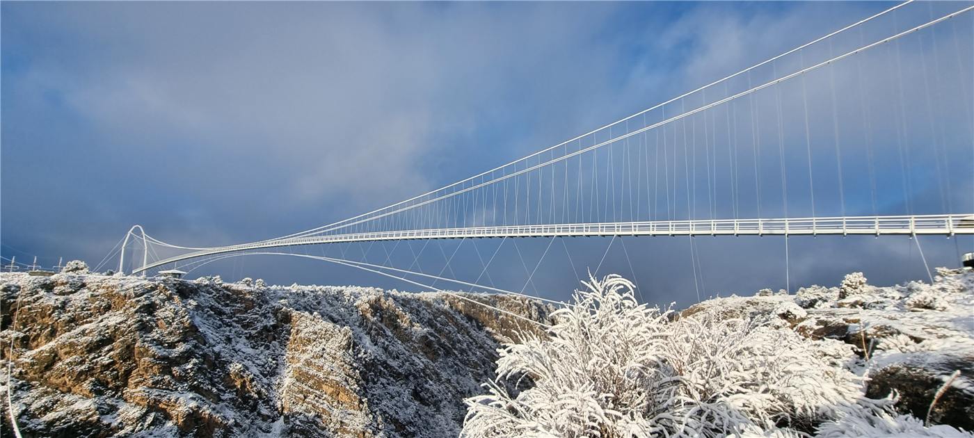 Suspension footbridge across a gorge in winter