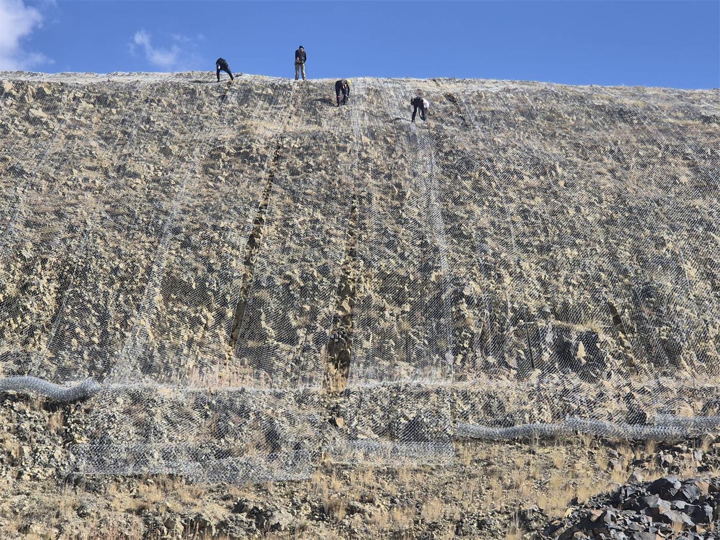 Fully draped slope with crew on the crest
