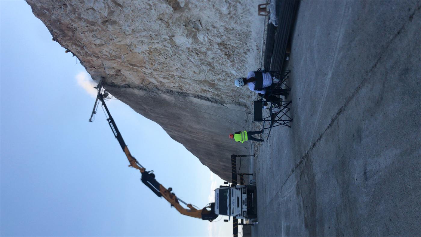 Drill rig working on an overhanging rock face