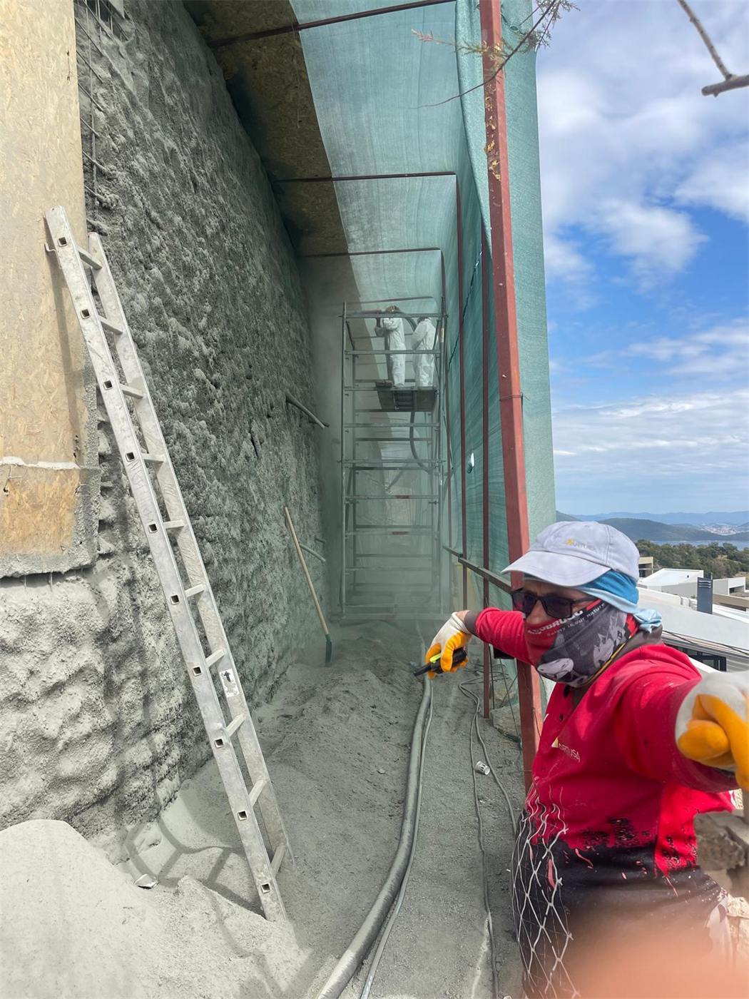 Hand nozzle shotcrete application close up
