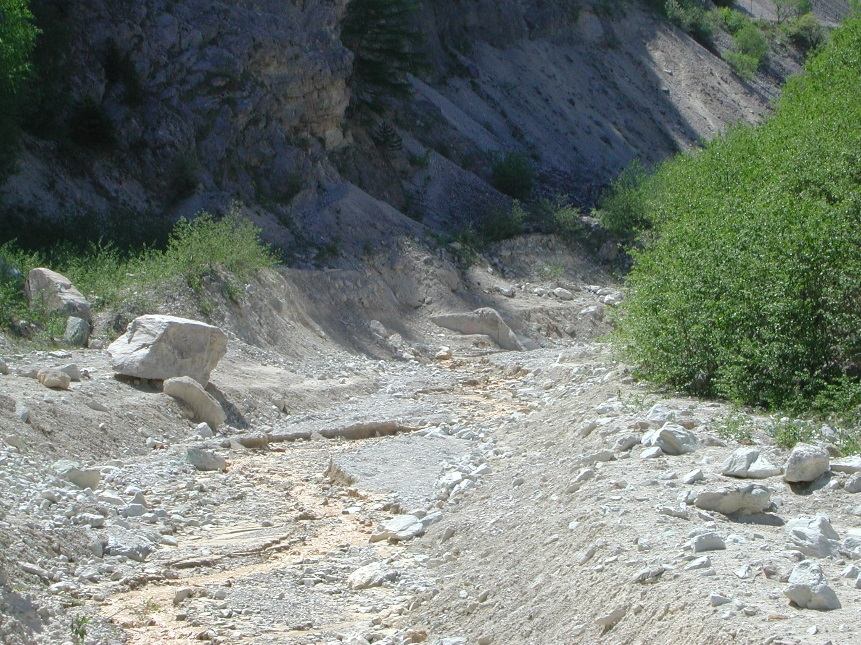 Torrent channel choked with debris and boulders