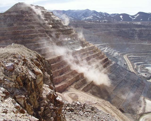 Bench failure with dust in an open pit mine