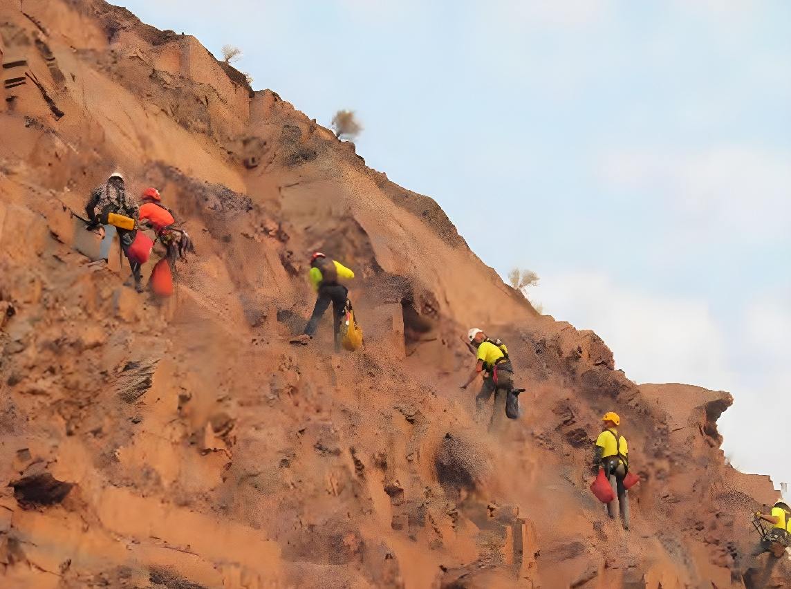Technicians scaling weathered red rock