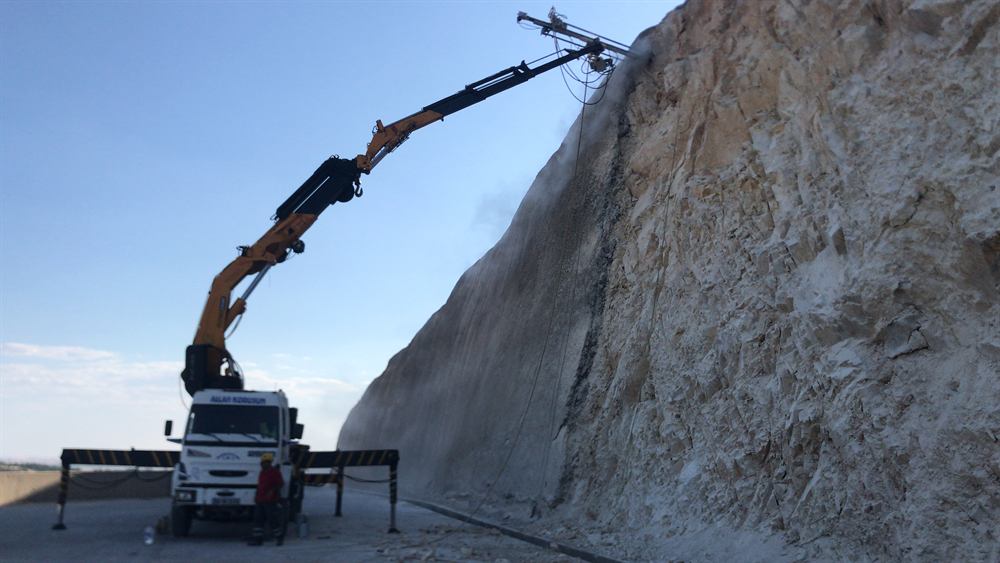 Truck-mounted drilling and anchoring at a rock cut
