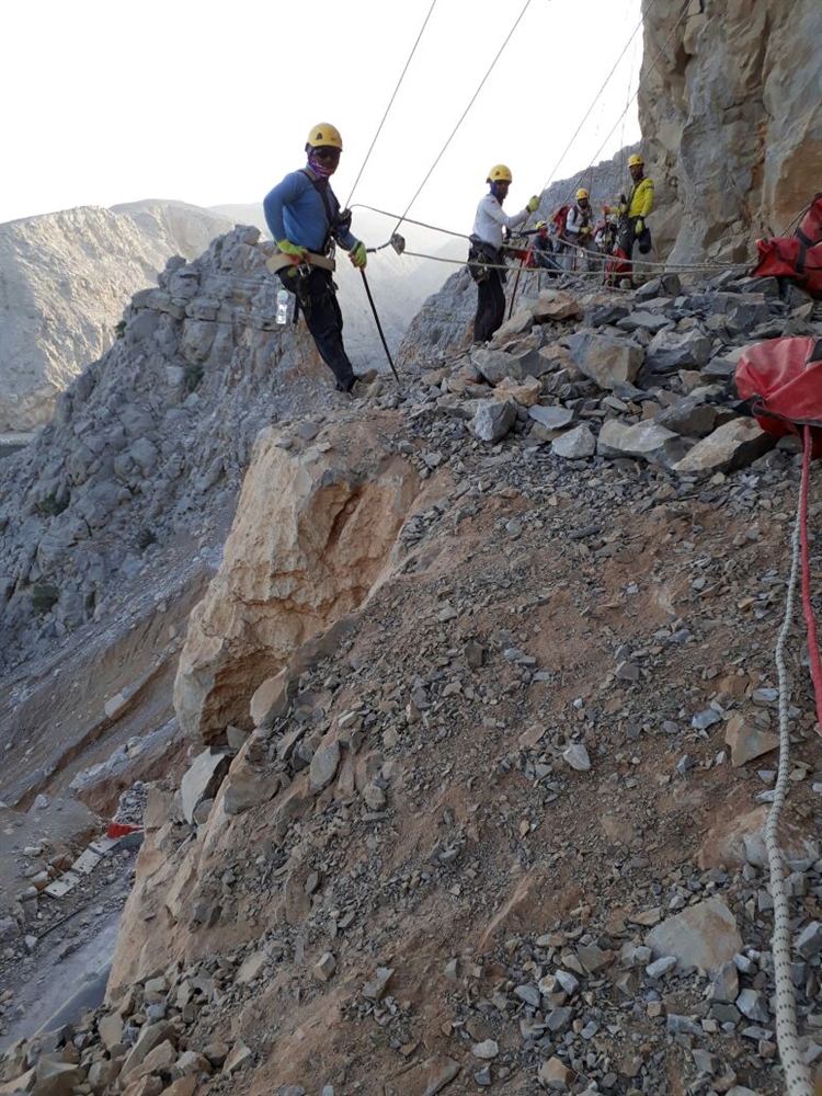 Rope-access crew on a rocky slope