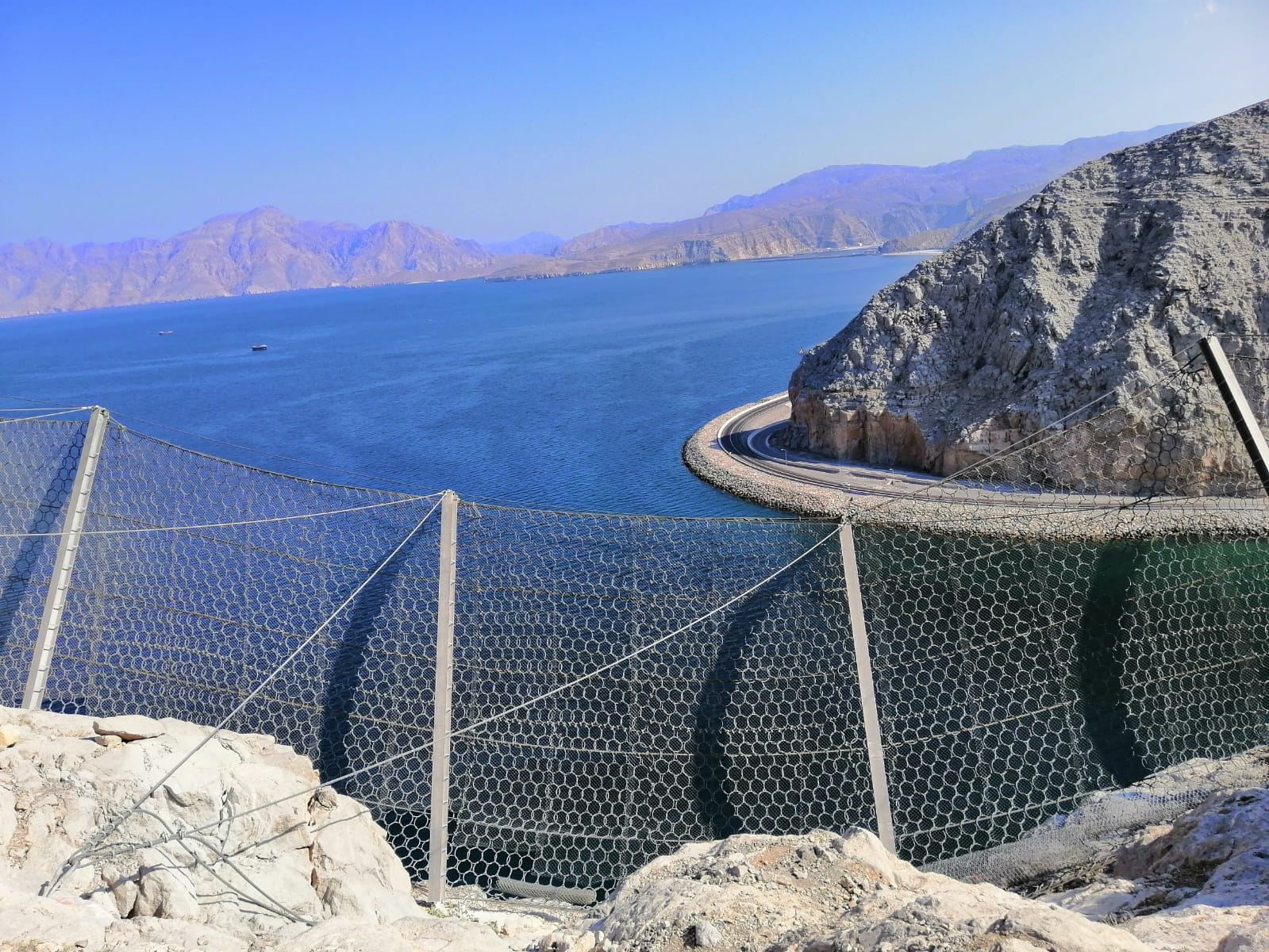 Ring-net barrier line above the Khasab–Tibat coastal road, Musandam
